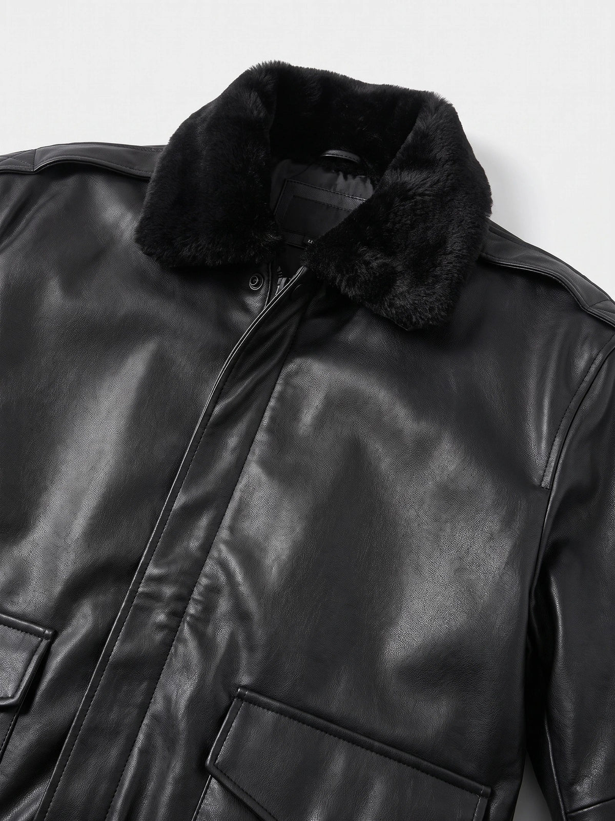Men's black leather bomber jacket by Bandalini with padded A-2 style design, suitable for winter, featuring detailed black accents.
