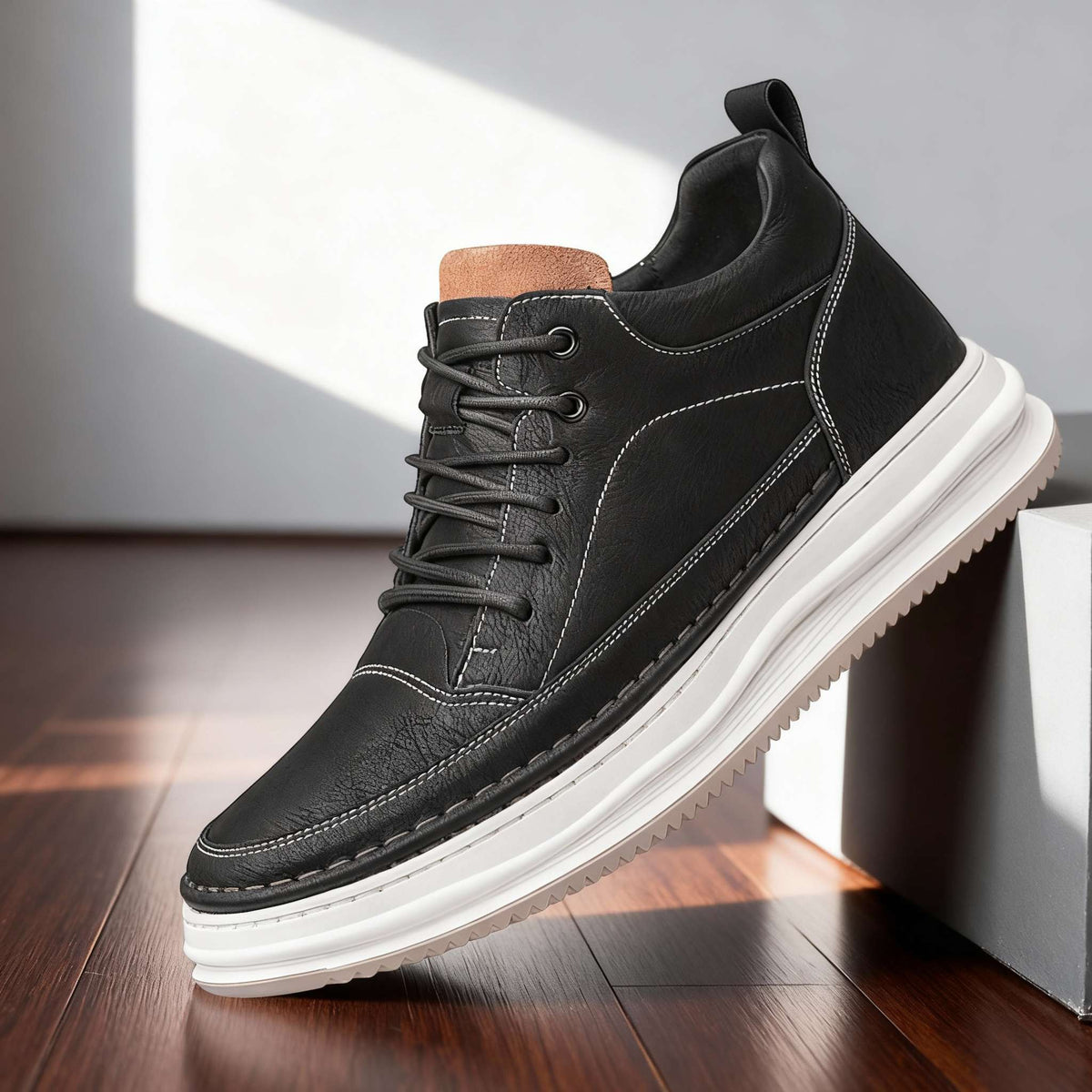 Men's textured leather casual sneakers by Bandalini with padded collar and cushioned insole on dark hardwood floor.